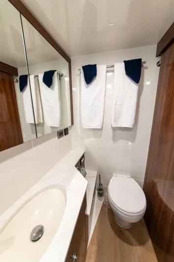 One More Yacht Photos Pics Luxurious bathroom in 2024 Maritimo M55 yacht with modern fixtures and elegant wood accents.