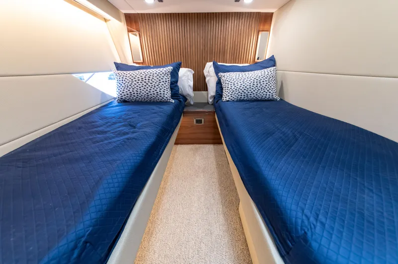 One More Yacht Photos Pics 2024 Maritimo M55 yacht cabin with twin beds, blue bedding, and modern design.