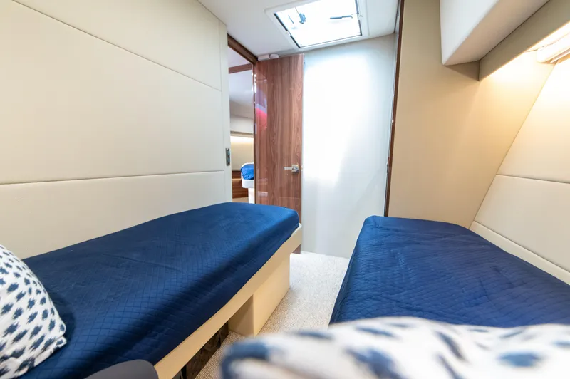 One More Yacht Photos Pics 2024 Maritimo M55 yacht cabin with twin beds and blue bedding.