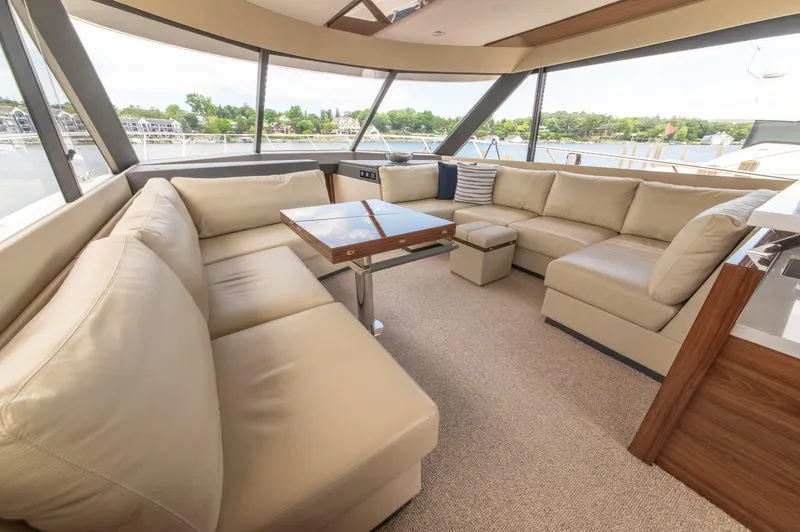 One More Yacht Photos Pics Luxurious interior of 2024 Maritimo M55 yacht with beige leather seating and panoramic windows.