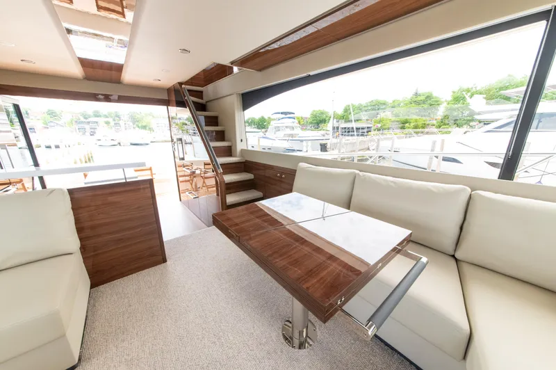 One More Yacht Photos Pics Luxurious interior of 2024 Maritimo M55 yacht with elegant seating and large windows.