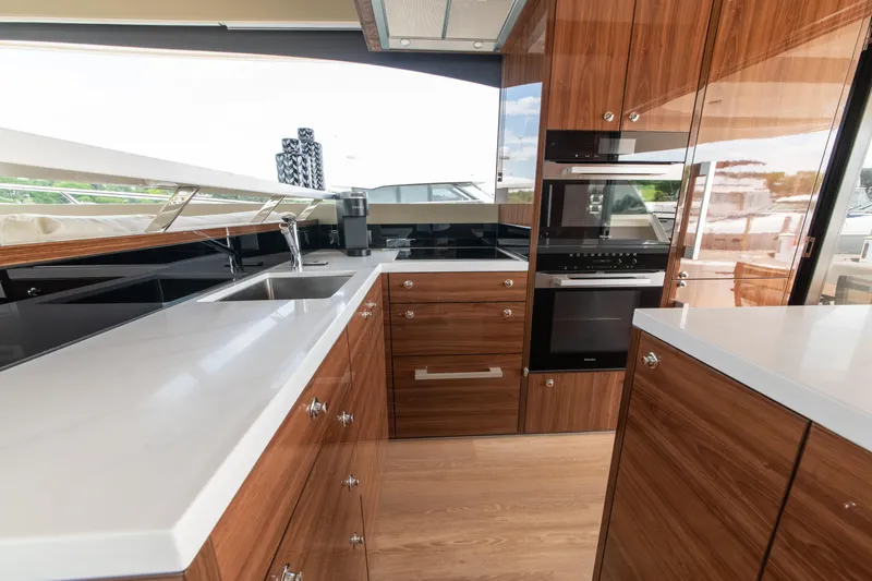 One More Yacht Photos Pics Luxurious kitchen interior of 2024 Maritimo M55 yacht with modern appliances and sleek design.