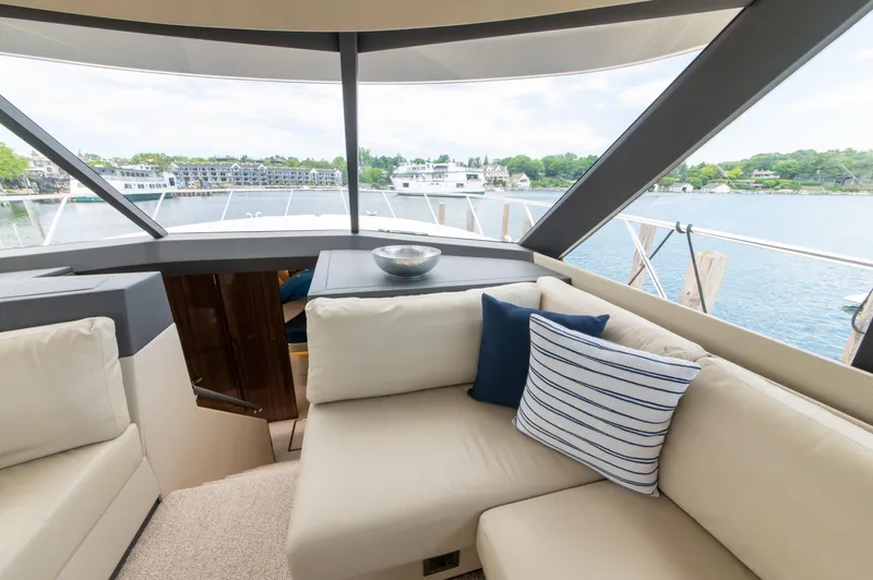 One More Yacht Photos Pics Luxurious interior of 2024 Maritimo M55 yacht with comfortable seating and scenic water view.