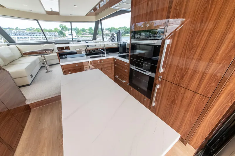 One More Yacht Photos Pics Luxurious 2024 Maritimo M55 yacht interior with modern kitchen and elegant wood finishes.