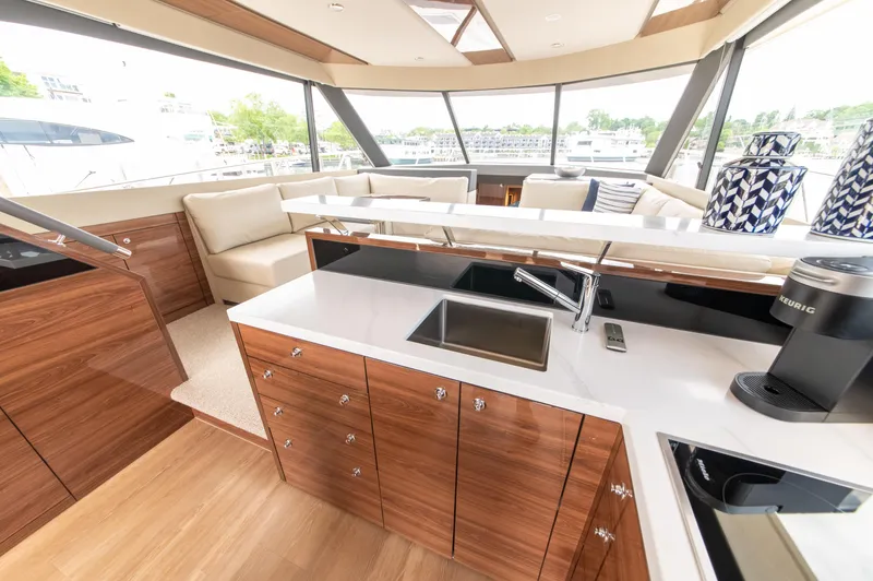 One More Yacht Photos Pics Luxurious interior of 2024 Maritimo M55 yacht with modern kitchen and seating area.