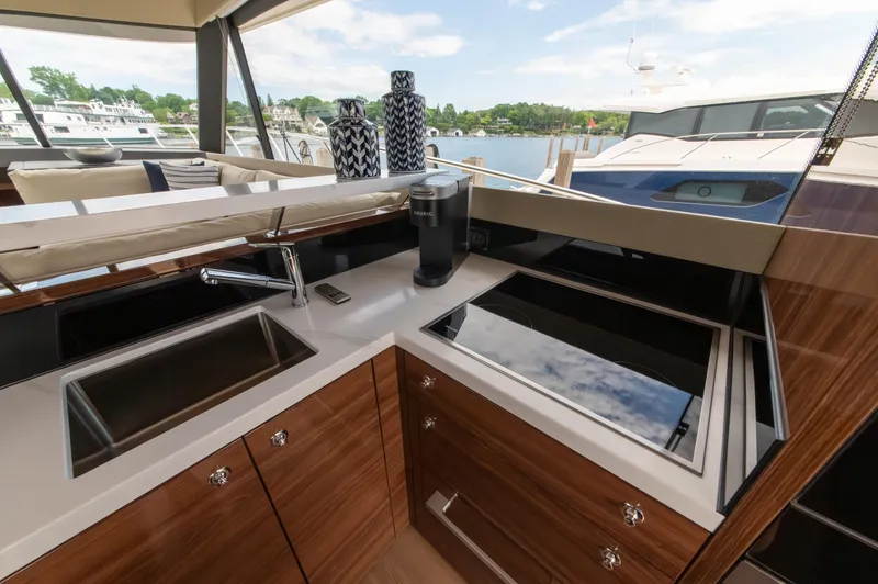 One More Yacht Photos Pics Luxurious 2024 Maritimo M55 yacht kitchen with modern appliances and sleek design.