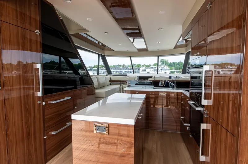 One More Yacht Photos Pics Luxurious interior of 2024 Maritimo M55 yacht with modern kitchen and panoramic windows.