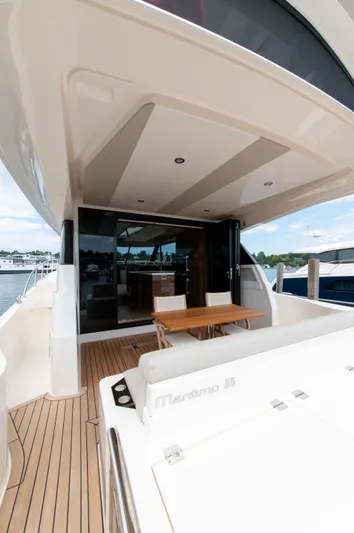 One More Yacht Photos Pics 2024 Maritimo M55 yacht deck with seating and table, docked at marina.