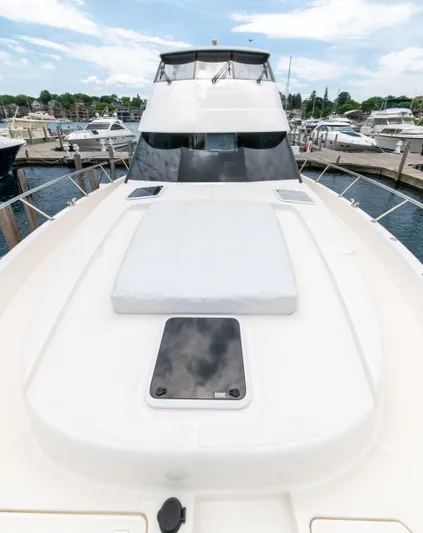 One More Yacht Photos Pics 2024 Maritimo M55 yacht docked at marina, showcasing sleek design and spacious deck.