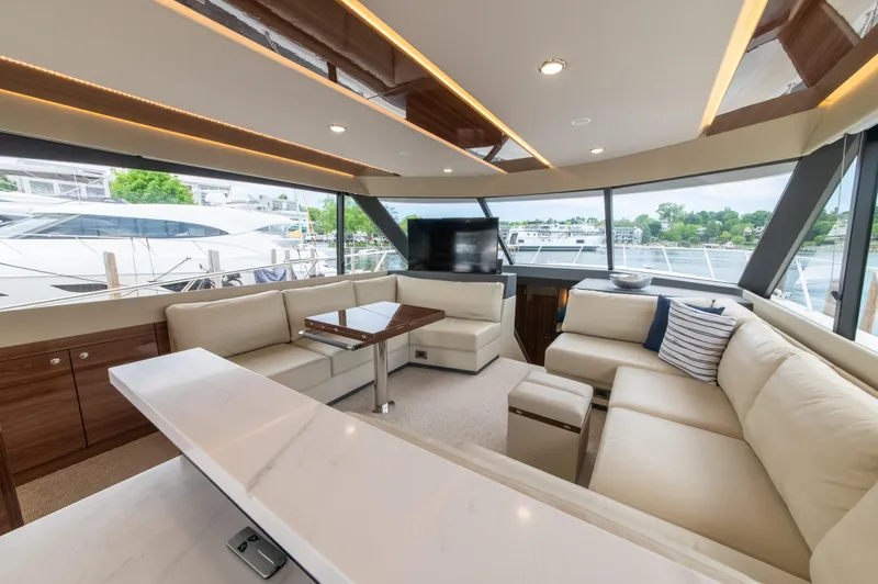 One More Yacht Photos Pics Luxurious interior of 2024 Maritimo M55 yacht with elegant seating and panoramic windows.