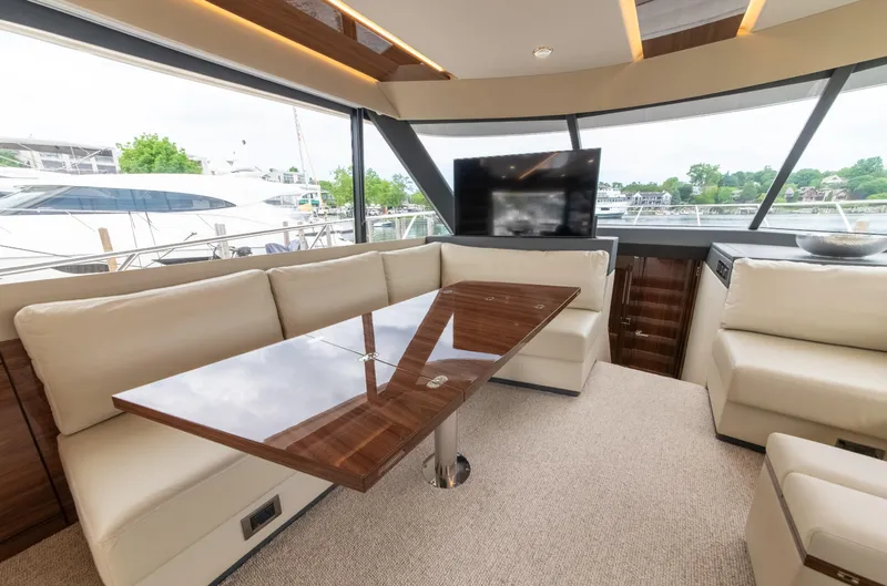 One More Yacht Photos Pics Luxurious interior of 2024 Maritimo M55 yacht with elegant seating and large windows.