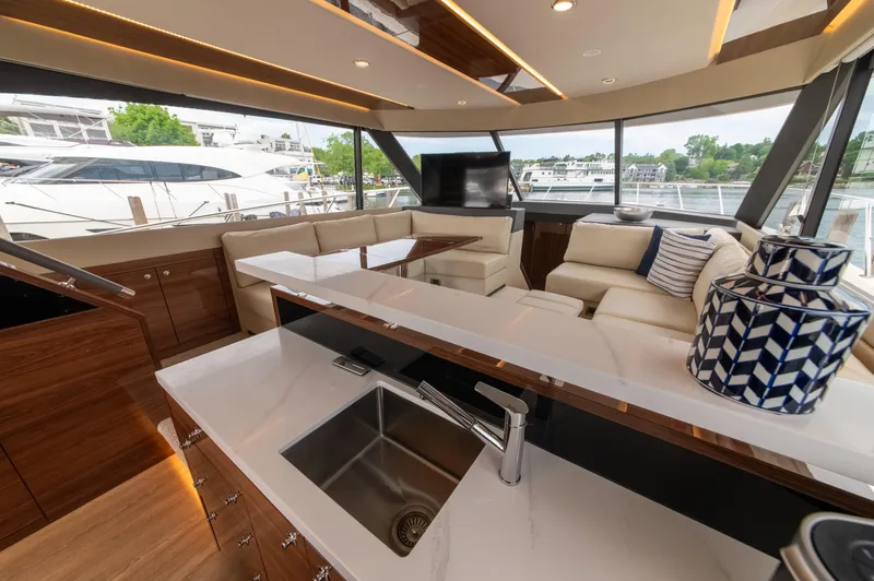 One More Yacht Photos Pics Luxurious interior of 2024 Maritimo M55 yacht with modern kitchen and seating area.