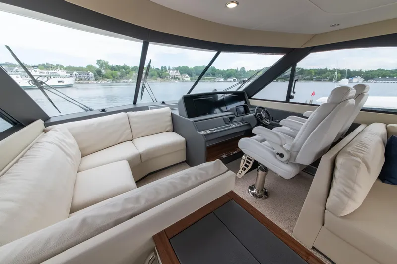 One More Yacht Photos Pics Luxurious interior of 2024 Maritimo M55 yacht with plush seating and panoramic windows.