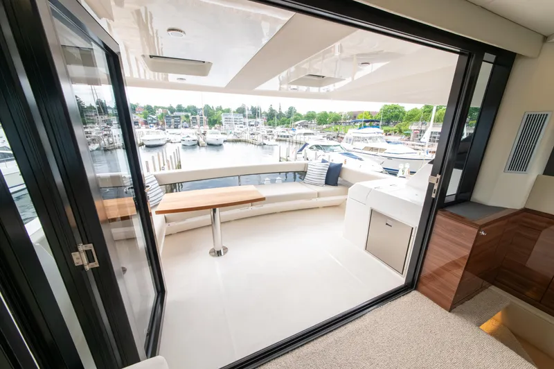 One More Yacht Photos Pics Luxurious 2024 Maritimo M55 yacht interior with marina view, featuring sleek design and comfortable seating.