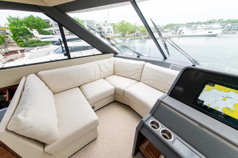 One More Yacht Photos Pics Luxurious interior of 2024 Maritimo M55 yacht with plush seating and navigation display.