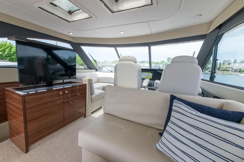 One More Yacht Photos Pics Luxurious interior of 2024 Maritimo M55 yacht with plush seating and modern entertainment system.