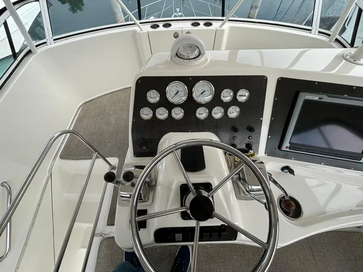  Yacht Photos Pics 2004 Silverton 38 Convertible boat helm with gauges and steering wheel.