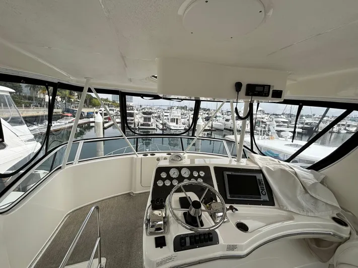  Yacht Photos Pics 2004 Silverton 38 Convertible yacht helm with marina view.