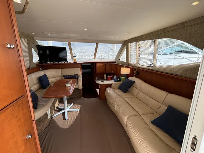  Yacht Photos Pics Interior of 2004 Silverton 38 Convertible yacht with beige seating and wooden accents.