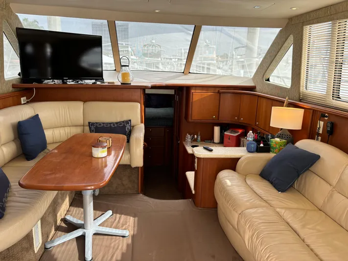  Yacht Photos Pics Interior of 2004 Silverton 38 Convertible yacht with leather seating and wooden table.