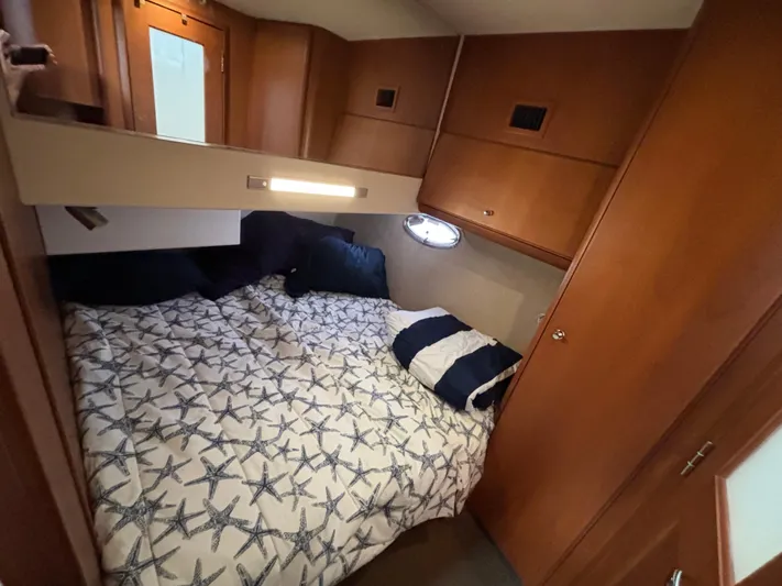  Yacht Photos Pics Cozy bedroom in 2004 Silverton 38 Convertible yacht with starfish-patterned bedding.