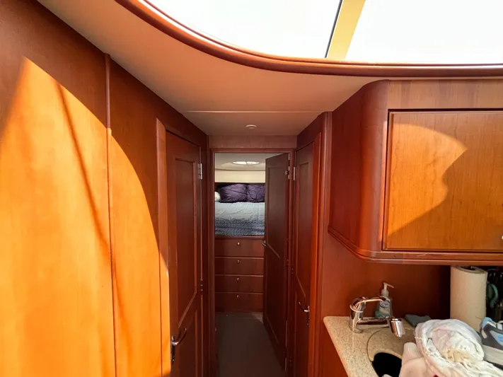  Yacht Photos Pics Interior of 2004 Silverton 38 Convertible yacht with wood cabinetry and cozy bedroom.