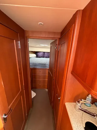  Yacht Photos Pics 2004 Silverton 38 Convertible yacht interior hallway with wood paneling and bedroom view.