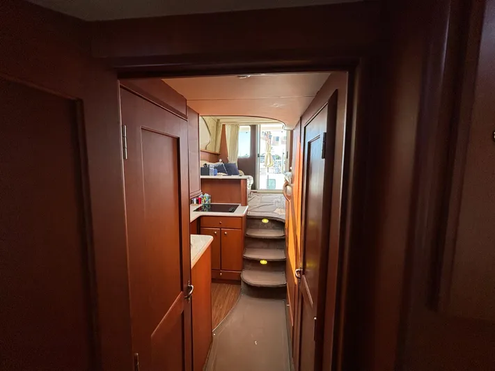  Yacht Photos Pics Interior of 2004 Silverton 38 Convertible yacht with wood paneling and compact kitchen.