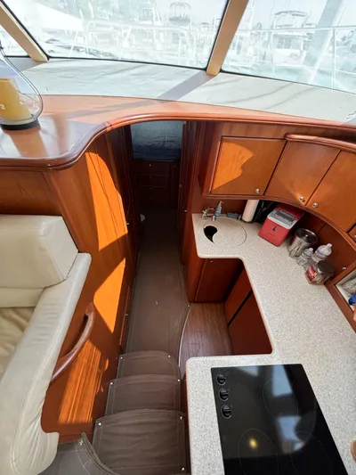  Yacht Photos Pics Interior of 2004 Silverton 38 Convertible yacht with modern kitchen and seating area.