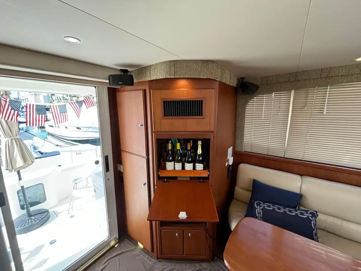  Yacht Photos Pics Luxurious interior of 2004 Silverton 38 Convertible yacht with wine cabinet and seating area.