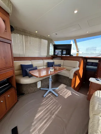  Yacht Photos Pics Interior of 2004 Silverton 38 Convertible yacht with cozy seating and dining area.