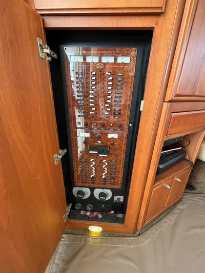  Yacht Photos Pics Electrical panel inside 2004 Silverton 38 Convertible yacht with wooden cabinetry.