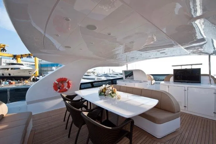  Yacht Photos Pics Luxurious 2009 Maiora 27 yacht deck with elegant seating and dining area.