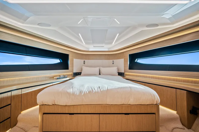 2023 Pearl 62 Luxury Yacht Yacht Photos Pics Luxurious bedroom interior of 2023 Pearl 62 yacht with modern design and panoramic windows.