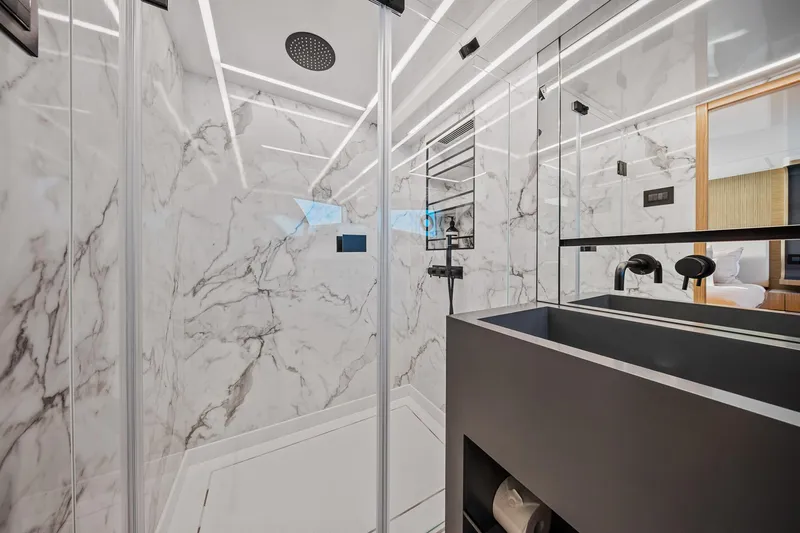 2023 Pearl 62 Luxury Yacht Yacht Photos Pics Luxurious modern bathroom with marble walls and sleek fixtures in a 2023 Pearl 62 model.