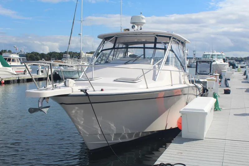 Karma Sea's Yacht Photos Pics 2001 Grady-White Express 330 boat docked at marina under blue sky.