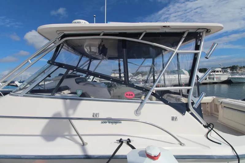 Karma Sea's Yacht Photos Pics 2001 Grady-White Express 330 boat docked, featuring sleek design and clear skies.