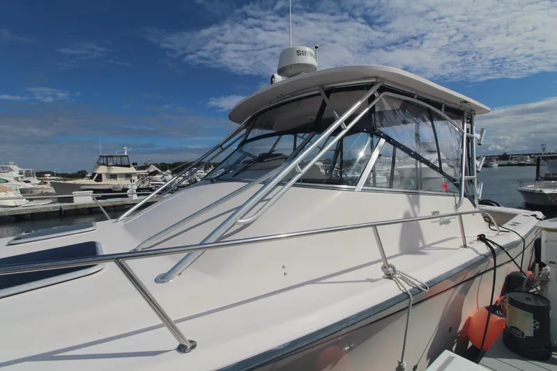 Karma Sea's Yacht Photos Pics 2001 Grady-White Express 330 boat docked at marina under blue sky.