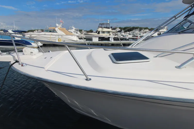 Karma Sea's Yacht Photos Pics 2001 Grady-White Express 330 boat docked in a marina under a clear blue sky.