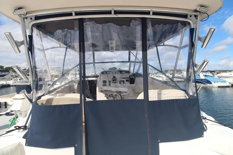 Karma Sea's Yacht Photos Pics 2001 Grady-White Express 330 boat with enclosed cockpit, docked at marina.