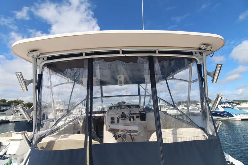 Karma Sea's Yacht Photos Pics 2001 Grady-White Express 330 boat with clear enclosure, docked under blue sky.