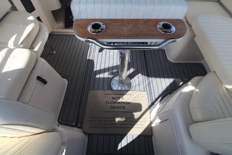 Karma Sea's Yacht Photos Pics 2001 Grady-White Express 330 boat interior with seating and table, featuring a safety warning.