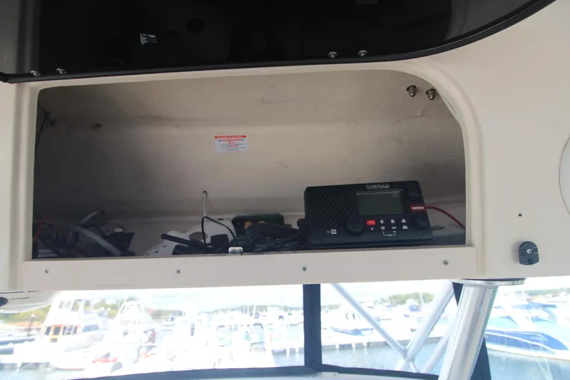 Karma Sea's Yacht Photos Pics 2001 Grady-White Express 330 boat interior with storage compartment and electronic equipment.