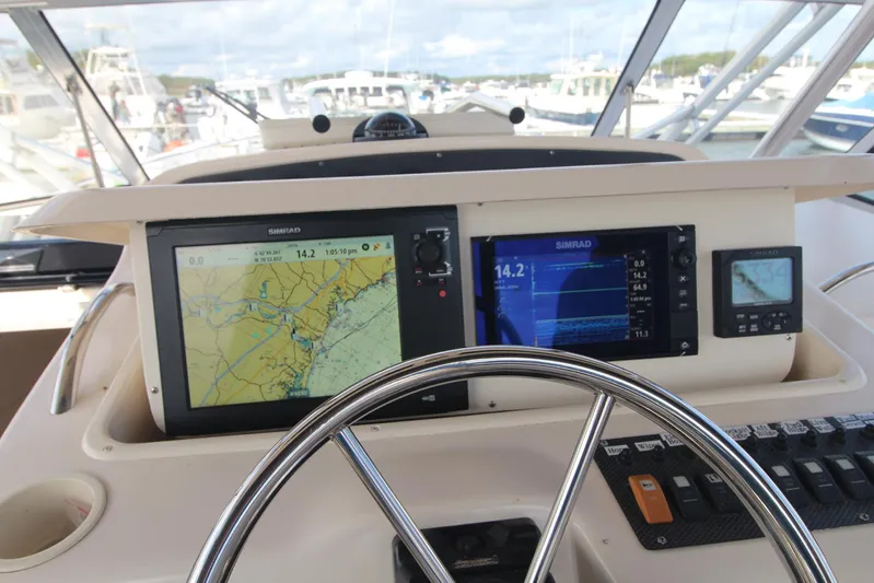 Karma Sea's Yacht Photos Pics Helm of 2001 Grady-White Express 330 with navigation screens and steering wheel.
