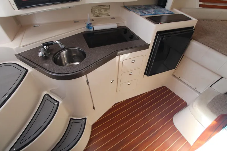 Karma Sea's Yacht Photos Pics 2001 Grady-White Express 330 boat interior with kitchenette and wood flooring.