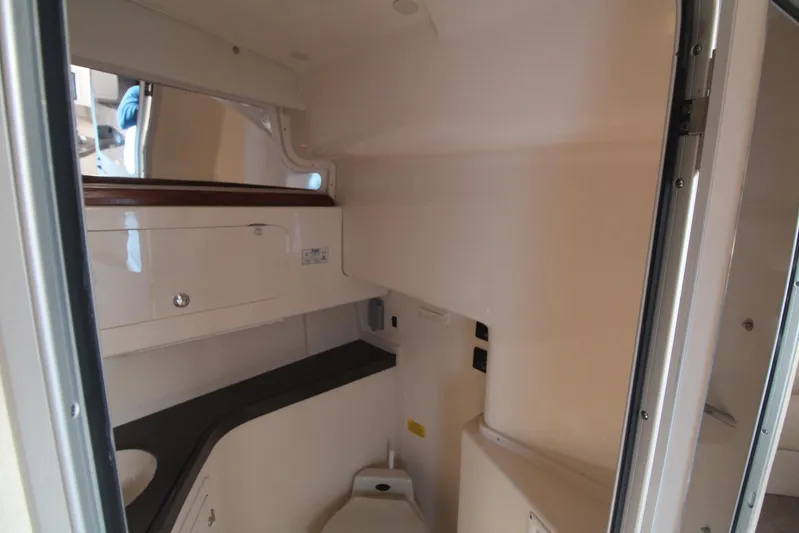 Karma Sea's Yacht Photos Pics 2001 Grady-White Express 330 boat interior with compact bathroom and storage.