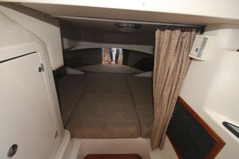 Karma Sea's Yacht Photos Pics 2001 Grady-White Express 330 cabin interior with bed, curtain, and storage.