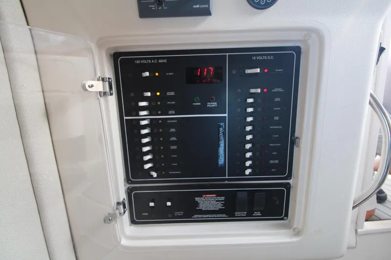 Karma Sea's Yacht Photos Pics Control panel of a 2001 Grady-White Express 330 boat, showing electrical switches and indicators.