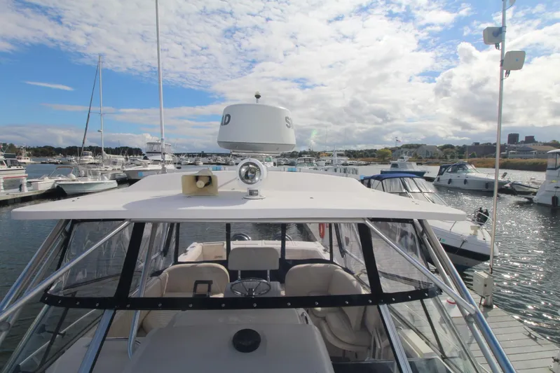 Karma Sea's Yacht Photos Pics 2001 Grady-White Express 330 boat docked in a marina under a partly cloudy sky.