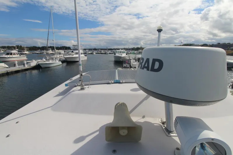 Karma Sea's Yacht Photos Pics 2001 Grady-White Express 330 boat docked in a marina with clear skies.